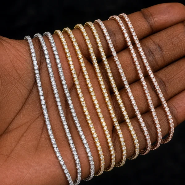 Close-up of a 3mm 14K gold color moissanite tennis bracelet on a woman’s wrist with hip hop streetwear styling.