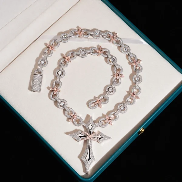 Coiled silver moissanite cross pendant necklace with star and infinity links on navy velvet